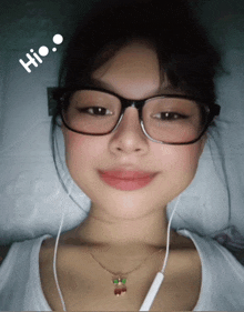 a girl wearing glasses and a necklace with the word hi on her head