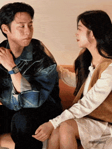 a man and a woman are sitting next to each other and jfricity.com is written on the bottom