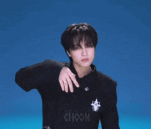 a man in a black jacket with the word choom on the back