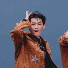 a man wearing a black shirt with the letter f on it is dancing