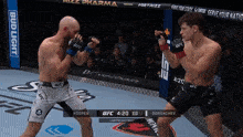 two men are fighting in a boxing ring with a bud light banner in the background