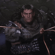 a man with a fur collar is wearing a green armor with spikes