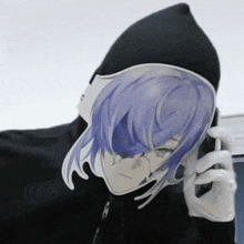 a person wearing a black hoodie with a sticker of a girl with purple hair talking on a phone