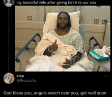 a man in a hospital bed is giving a thumbs up sign