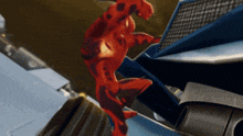 a cartoon character in a red suit is jumping over a building