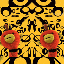 two stuffed animals are in front of a yellow background