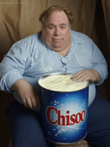 a man is holding a can of chisoo