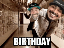 two men are dancing in a hallway with the words birthday written on the floor