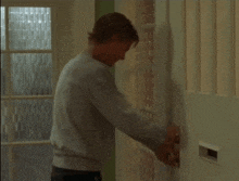 a man is trying to open a door with a key in it