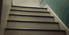 a close up of a set of stairs with a blue wall in the background .
