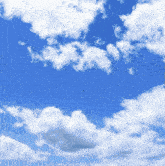 a blue sky with white clouds and a small bird in the distance