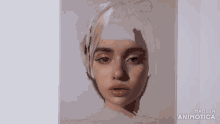 a close up of a painting of a woman 's face being painted on a piece of paper .