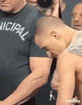 a man wearing a shirt that says nicipal looks down