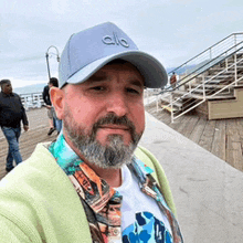 a man with a beard is wearing a hat that says ' a ' on it