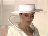 a woman is wearing a white hat and a white jacket