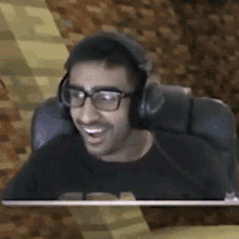 a man wearing headphones and glasses is sitting in a chair and making a funny face .