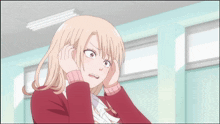 a girl covering her ears with her hands in a room