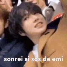 a close up of a person 's face with the words sonrei si sos de emi written below it