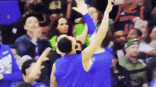 a basketball player in a blue jersey with the letter n on it