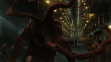 a large red monster is walking through a prison building