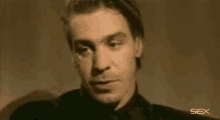 a close up of a man 's face with the word sex visible in the corner .