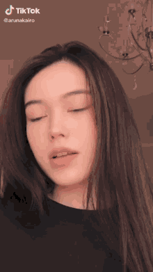 a woman with her eyes closed has a tiktok watermark on her face