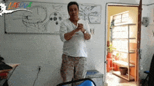 a man stands in front of a white board that says la edu on it