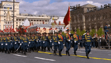 a military parade in a city with a flag that says cccp on it