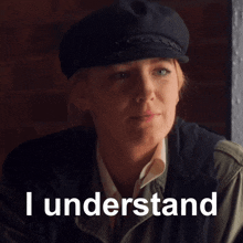 a woman wearing a hat with the words i understand written below her
