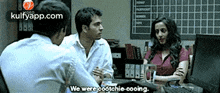 a group of people are sitting around a table and one of them is saying we were cootchie cooing