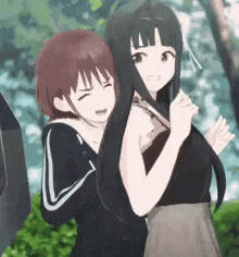 a couple of anime girls are standing next to each other and one of them is holding a knife .