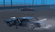 a screenshot of a video game shows a man standing next to a blue car with a purple car behind it
