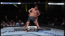two men are fighting in a boxing ring with a toyo tires advertisement