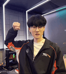 a young man wearing glasses and a jacket that says ' a ' on it
