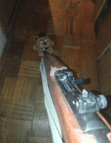 a rifle with a teddy bear on it