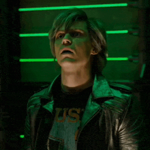 a man wearing a us t-shirt and a black leather jacket