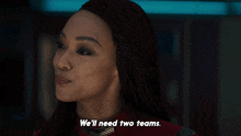 a woman says " we 'll need two teams " in a dark room
