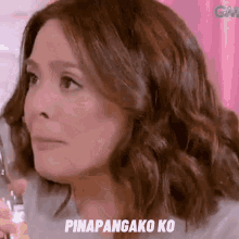 a close up of a woman 's face with the words pinapangako ko written on the bottom