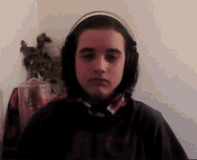 a young boy wearing headphones and a shirt that says ' ncs ' on it