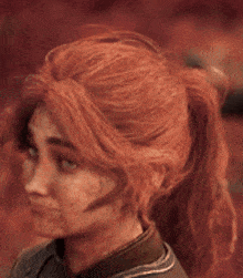 a close up of a person 's face with red hair and blue eyes .