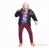 a man in a black jacket and red pants dancing