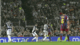 a soccer player wearing a number 6 jersey runs towards another player