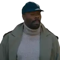a man wearing a trench coat and a turtleneck sweater