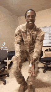 a man in a military uniform is dancing in a room with a chair