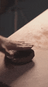 a close up of a person 's hands on a wooden table