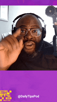 a man wearing glasses and headphones talks into a microphone on a daily tipspod