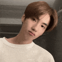 a close up of a young man 's face with the words photochan gif below it