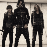 a man in a black jacket with a cross on it