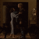 a man and a woman hugging in a dark room