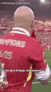 a man wearing a red jersey that says ' champions ' on it